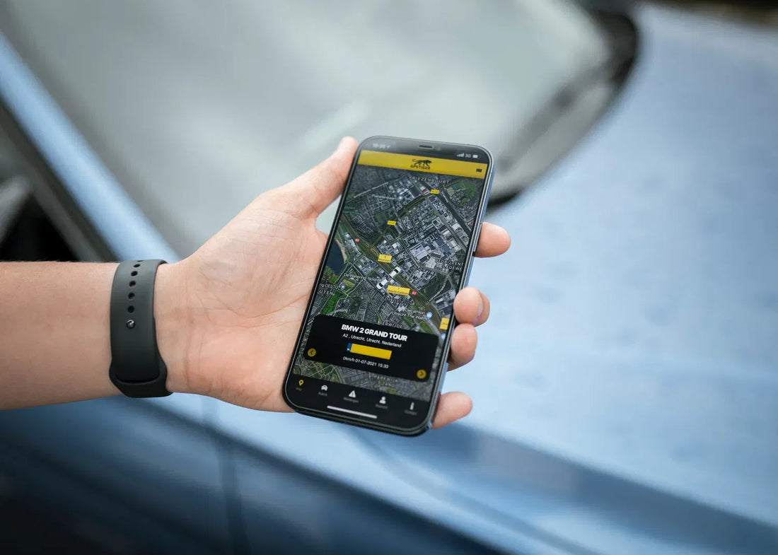 Driver viewing a live vehicle tracking app on a smartphone beside a car