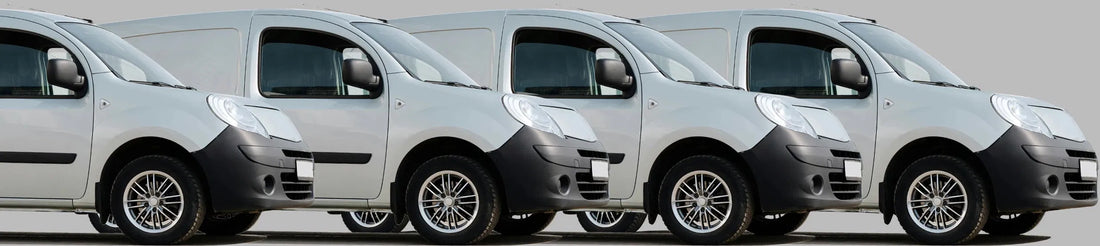A row of white business vans ready for monitoring with DrivePro